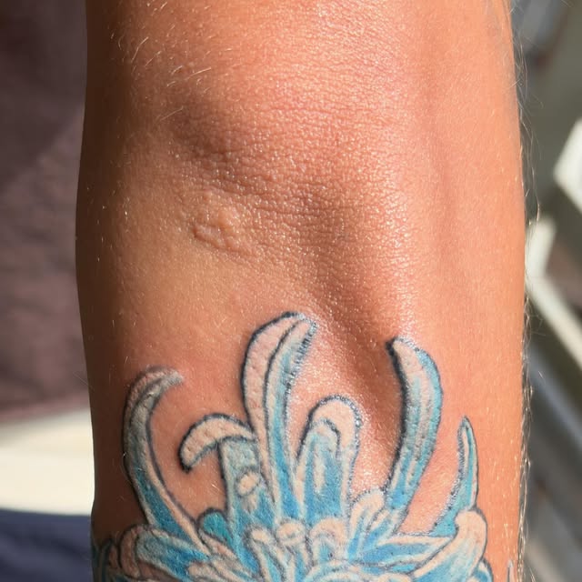 Blue chrysanthemum tattoo by Kyle at Maui Tattoos