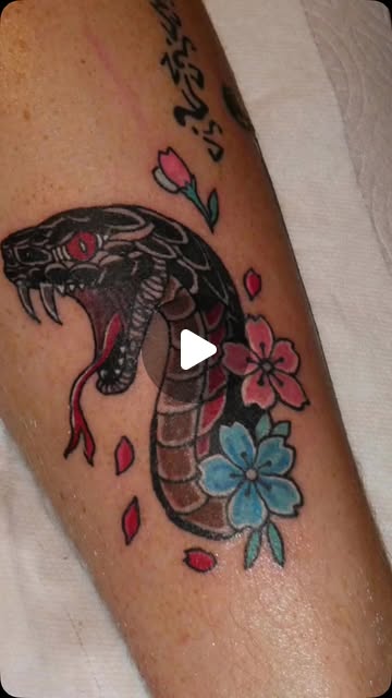 Snake and flowers tattoo by Kyle at Maui Tattoos